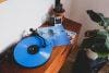 blue vinyl record on brown wooden table nirvana grunge