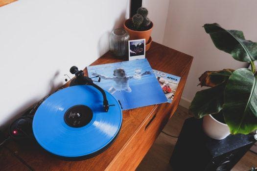 blue vinyl record on brown wooden table nirvana grunge